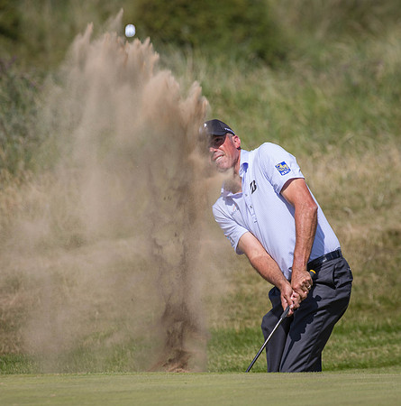 Matt Kuchar chips out of a bunker
