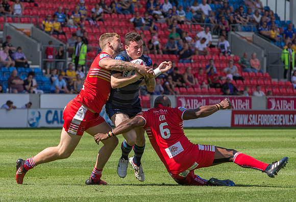 Jordan Lilley of Leeds Rhino's is blocked out by the Salford line