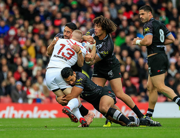 Kevin Proctor of New Zealand tackles Luke Thompson